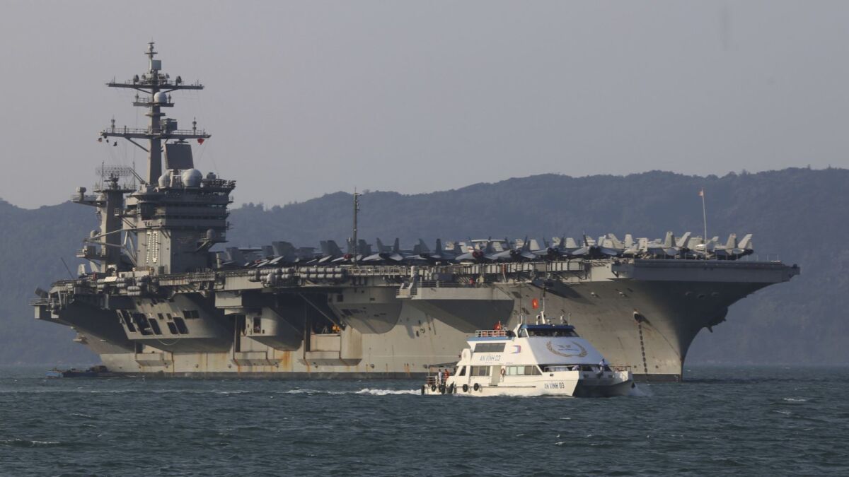 The U.S. aircraft carrier Carl Vinson docks in Vietnam in 2018. A sailor who served on the ship has pleaded guilty to espionage charges.