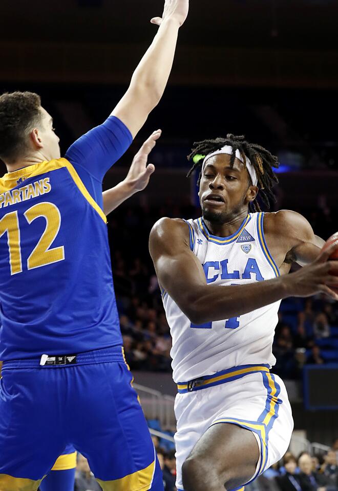 UCLA forward Jalen Hill goes to the basket against San Jose State forward Eduardo Lane.