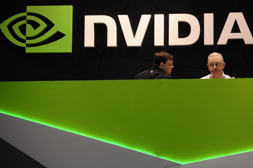 FILE - People gather in the Nvidia booth at the Mobile World Congress mobile phone trade show Thursday, Feb. 27, 2014 in Barcelona, Spain. Nvidia has joined the exclusive club of companies with a $1 trillion market capitalization, Tuesday, May 30, 2023, as the chipmaker benefits from the growing use of artificial intelligence. Nvidia Corp. joins companies like Alphabet, Apple and Microsoft in the $1 trillion club. (AP Photo/Manu Fernandez, File)