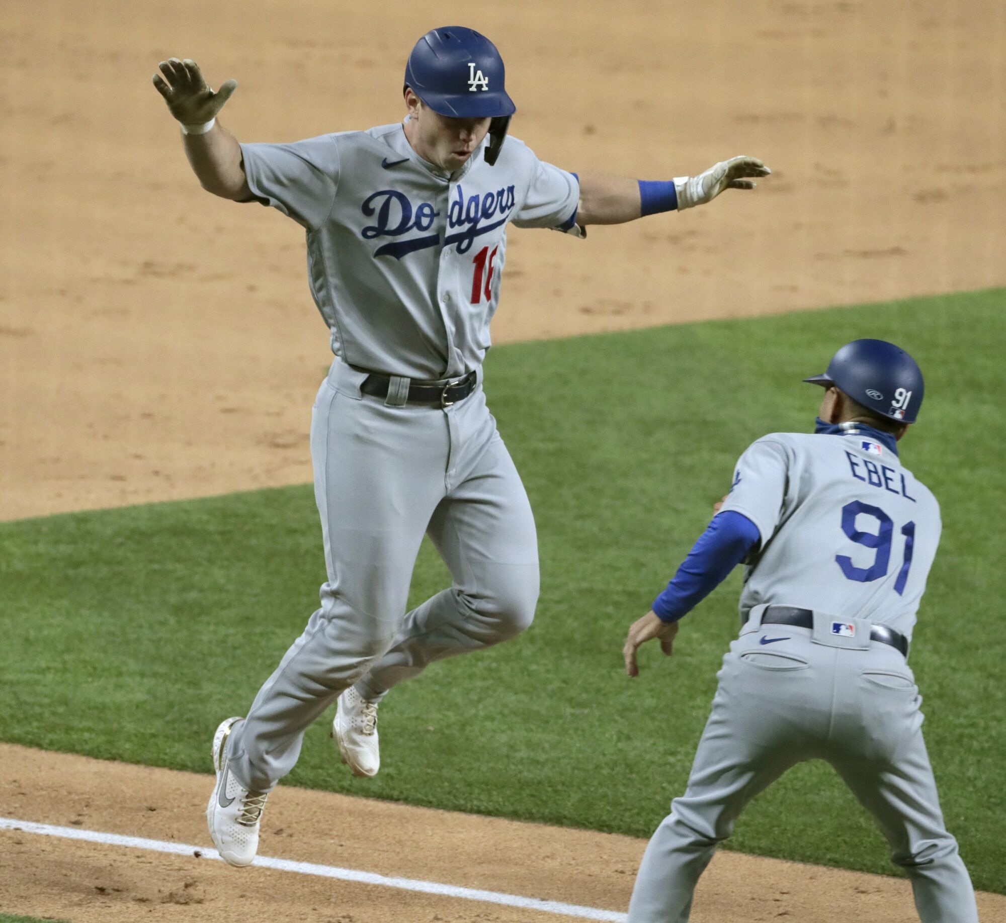 Dodgers catcher Will Smith celebrates with third base coach Dino Ebel after hitting a three-run home run.