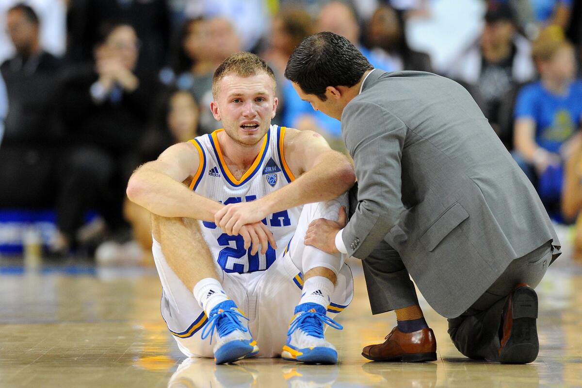 UCLA guard Bryce Alford is looked at by a trainer after a collision during game against Oregon State on March 5.