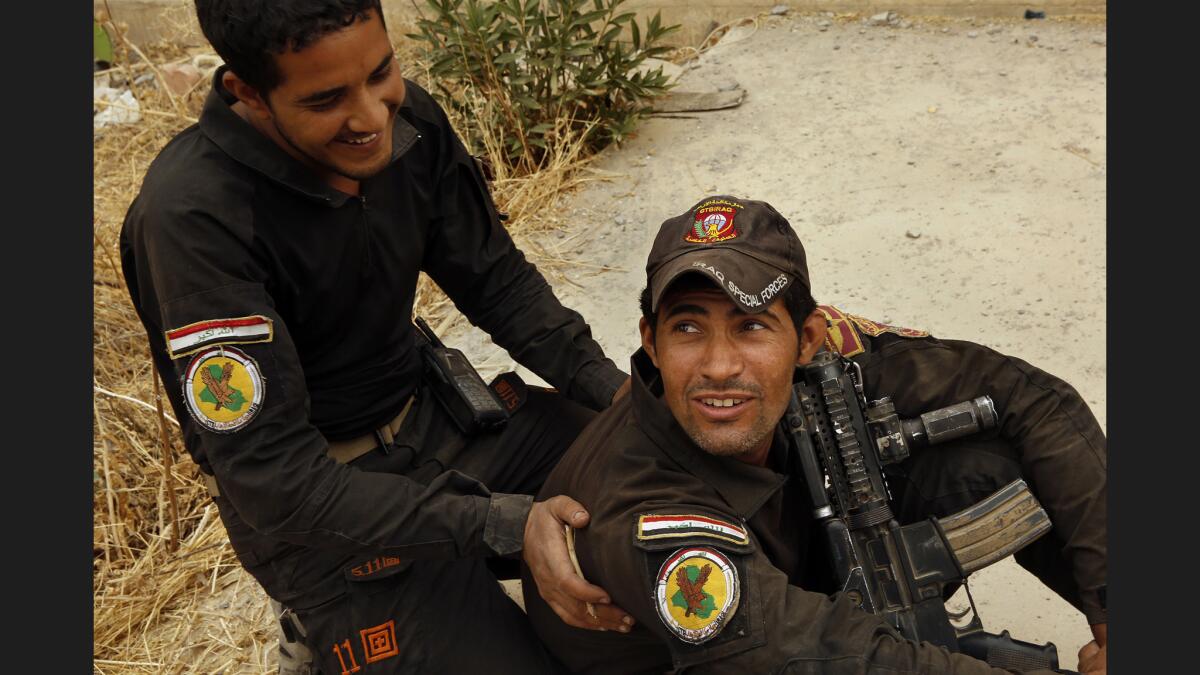 Waleed Abdel Nabi, right, and a fellow Iraqi special force fighter in the town of Bartella.