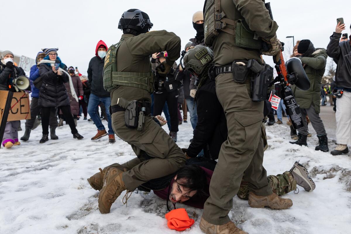 Protesters clash with law enforcement outside an ICE facility in Minneapolis, on Thursday.