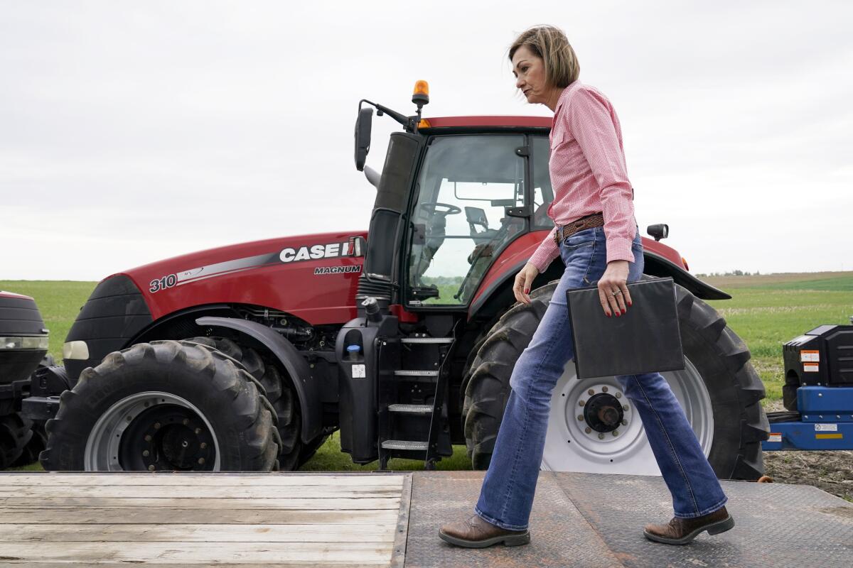 Iowa Gov. Kim Reynolds arrives to sign the Biofuels Bill, Tuesday, May 17, 2022, in Prairie City, Iowa. (AP Photo/Charlie Neibergall)