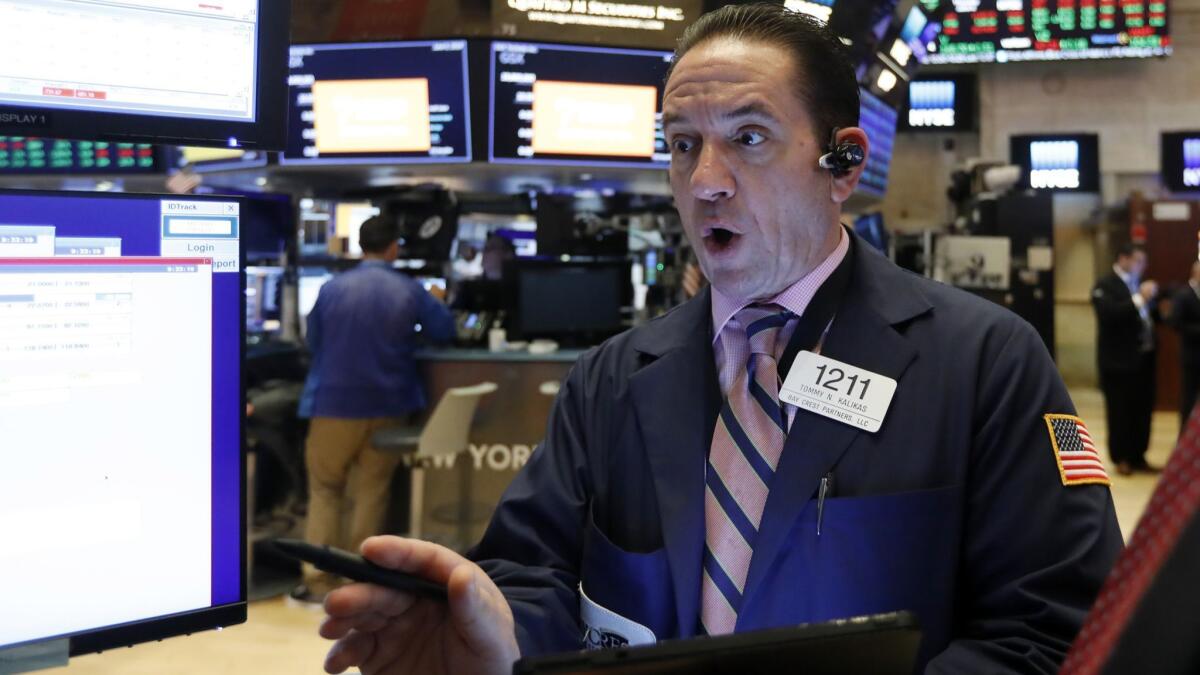 The Dow Jones industrial average climbed 0.7% to 25,720.66 on Thursday. Above, trader Tommy Kalikas at the New York Stock Exchange.