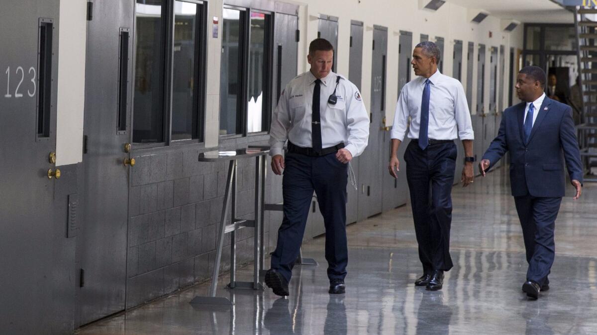 President Obama is led on a tour by Bureau of Prisons Director Charles Samuels, right, and correctional officer Ronald Warlick during a visit to the El Reno Federal Correctional Institution in El Reno, Okla. on July 16, 2015.