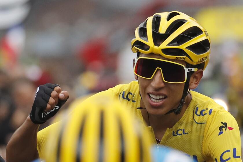 Colombia's Egan Bernal wearing the overall leader's yellow jersey celebrates as he crosses the finish line of the twentieth stage of the Tour de France cycling race over 59,5 kilometers (36,97 miles) with start in Albertville and finish in Val Thorens, France, Saturday, July 27, 2019. (AP Photo/Christophe Ena)