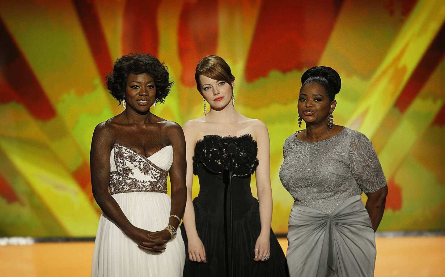 Actresses Viola Davis, Emma Stone and Octavia Spencer assemble onstage to present their film, "The Help," for the evening's top award.