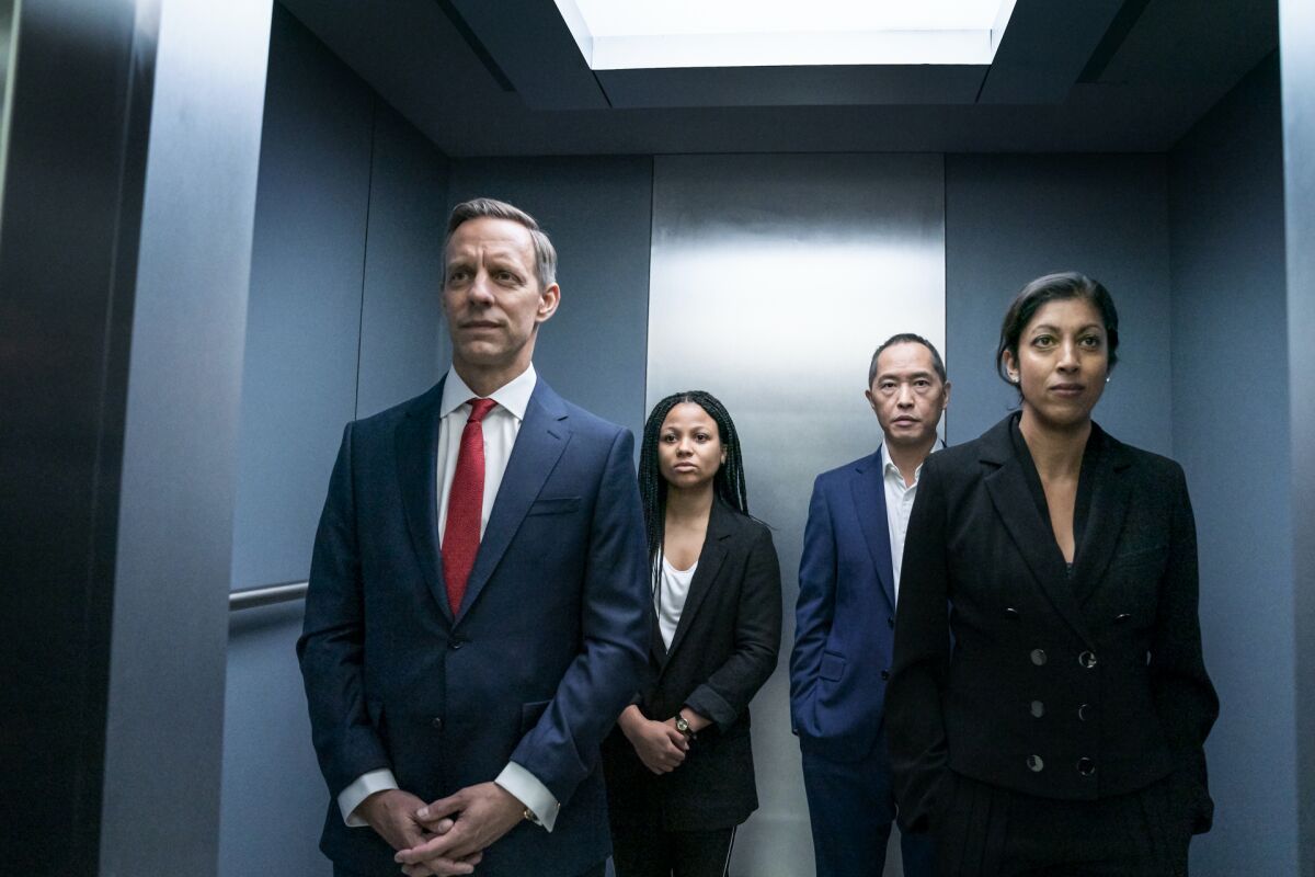 Four businesspeople in an elevator