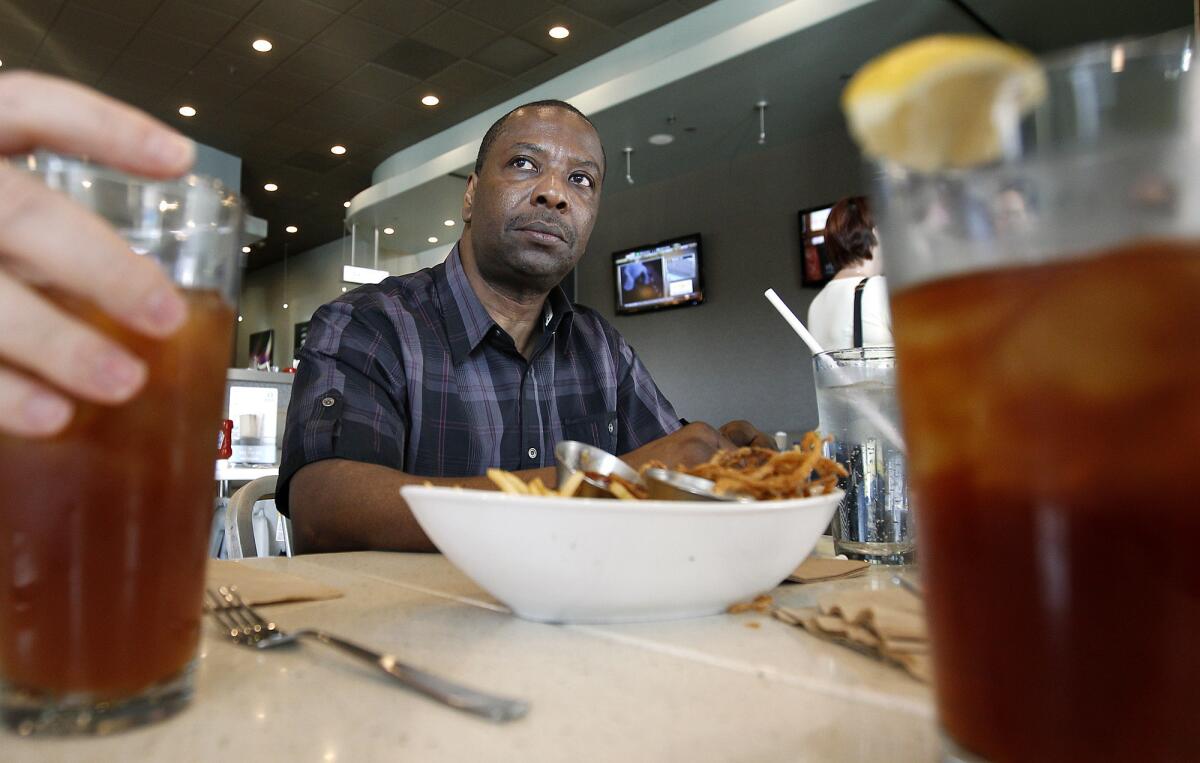 Kash Register dines at a burger joint in Los Angeles in November after his murder conviction was overturned. Prosecutors say they will not refile charges.