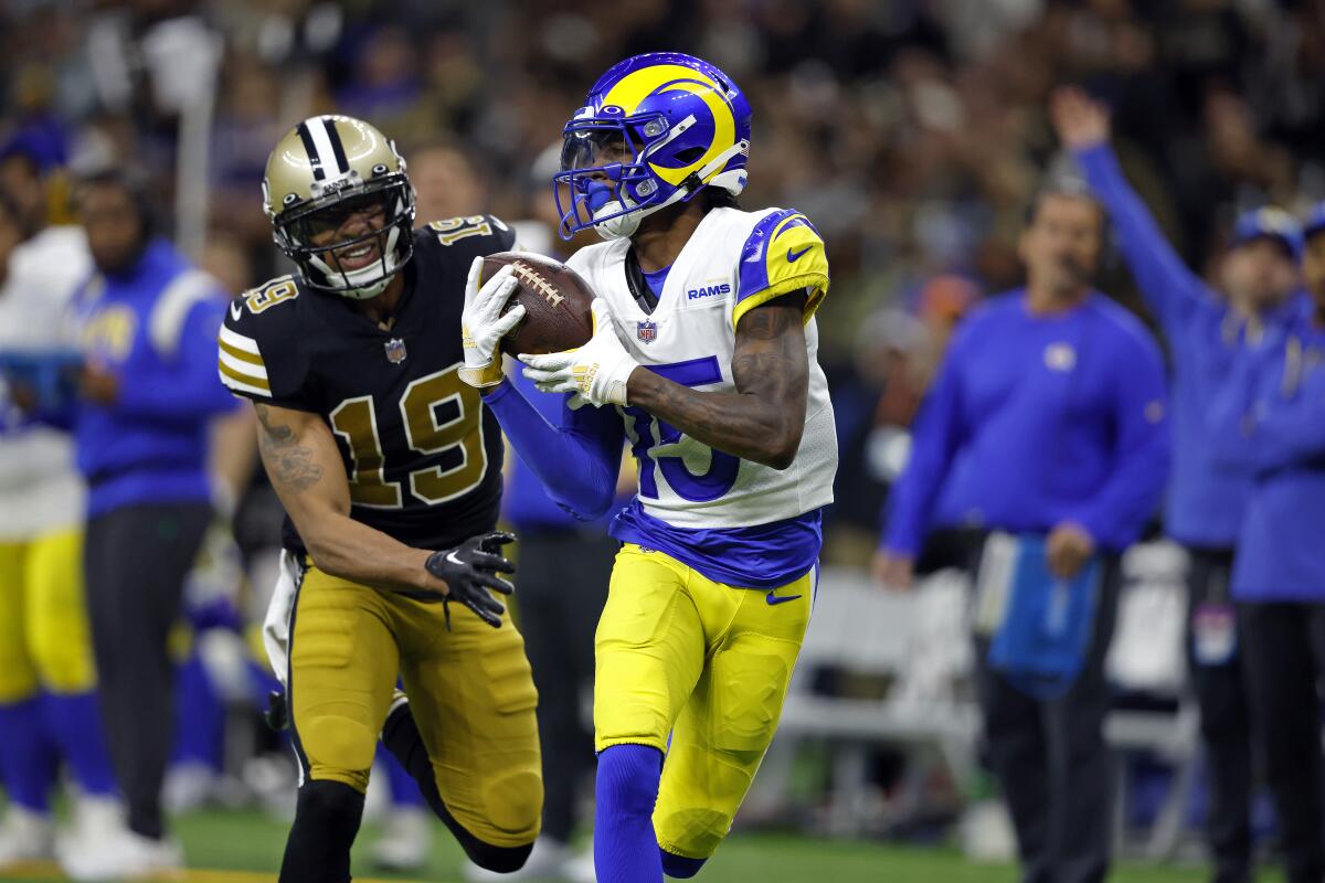 Rams wide receiver Tutu Atwell (15) catches the ball past Saints safety Chris Harris Jr. (19) for a 62-yard touchdown. 
