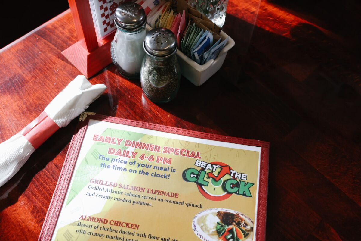 A menu sits on a diner table