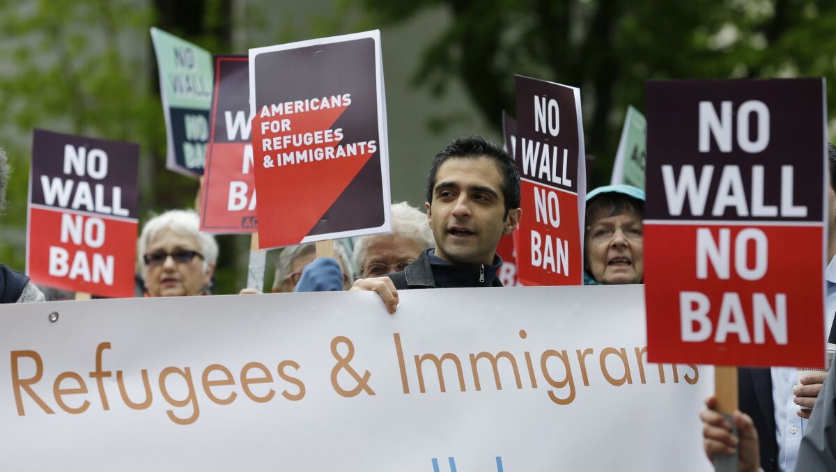 Protesters rally against President Trump's travel and refugee ban on May 15, 2017, outside a federal courthouse in Seattle.