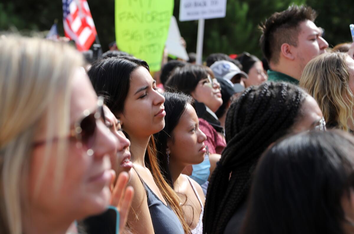 Female students from UC Irvine listen to Rep. Alexandria Ocasio-Cortez speak.