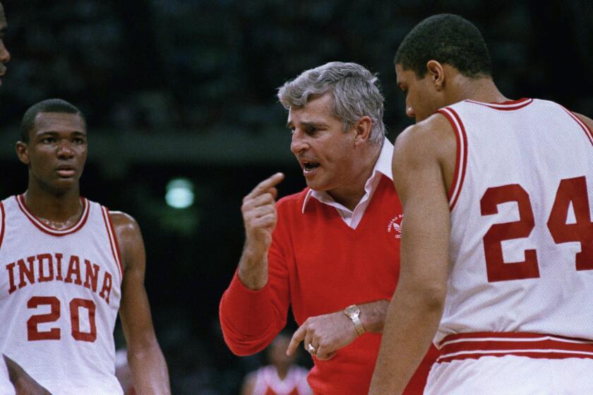 Indiana coach Bobby Knight gestures while instructing his players as the Hoosiers.