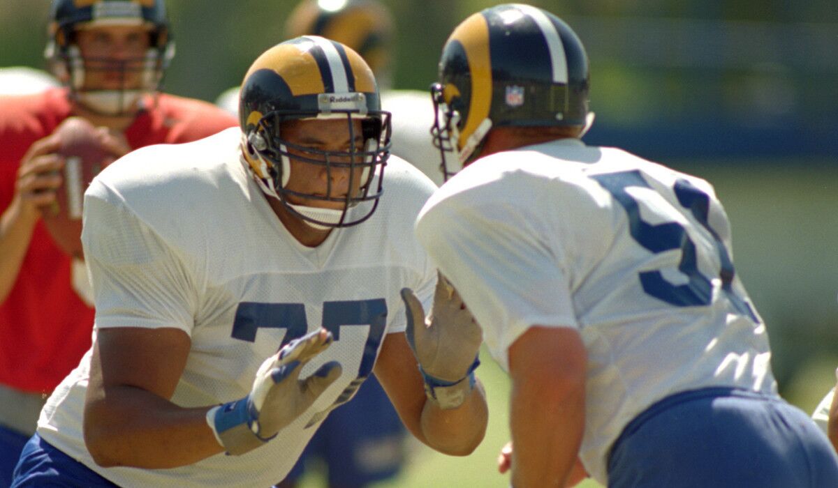 Darryl Ashmore (77), pictured at an L.A. Rams practice at UC Irvine in 1994, suffers from physical and cognitive problems, including early-onset dementia. according to a lawsuit he filed this week.