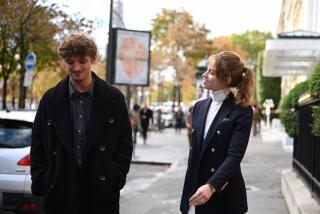 A man and a woman flirt and walk.