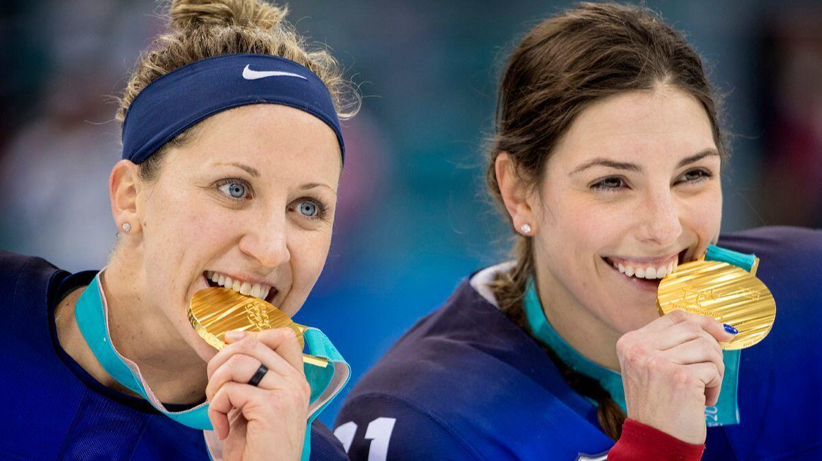 U.S. women's hockey players Meghan Duggan, left, and Hilary Knight with gold medals after defeating Canada at Gangneung Hockey Centre on Thursday.