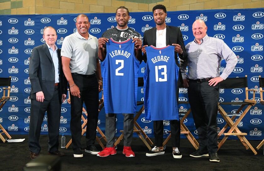 From left, Clippers president of Basketball Operations Lawrence Frank, head coach Doc Rivers, new players Kawhi Leonard  and Paul George and owner Steve Balmer pose for a photo at Green Meadows Recreation Center during a press conference in Los Angeles on Wednesday. 