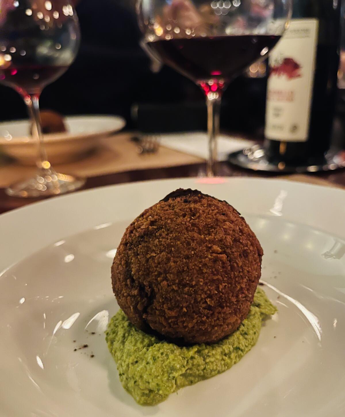 Sarah Cicolini's oxtail meatball with peanut and lovage sauce, dusted with cocoa,