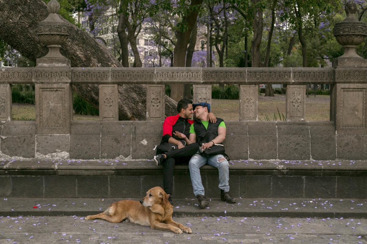 Eduardo, 26, left, and Jorge, 35, embrace in Mexico City's Alameda Central park. Like many public spaces in Mexico City, the park is often filled with couples publicly displaying their affection.