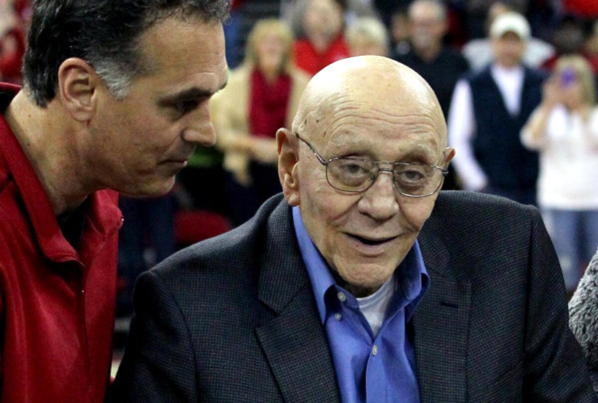 Jerry Tarkanian is escorted by son Danny during halftime ceremonies at Fresno State, which honored the former coach.