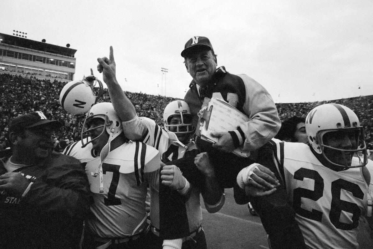 FILE - In this Nov. 25, 1971, file photo, Nebraska head coach Bob Devaney is carried off the field by his victorious players after they defeated Oklahoma 35-31 in an NCAA college football game in Norman, Okla., on Thanksgiving Day. The game on Thanksgiving 50 years ago is back in the spotlight as Nebraska and Oklahoma renew their rivalry on Saturday, Sept. 18, 2021. (AP Photo/File)