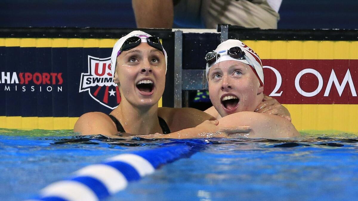 Lilly King, right, and Katie Meili, left, look at the results after King won the women's 100-meter breaststroke final on June 28, 2016.