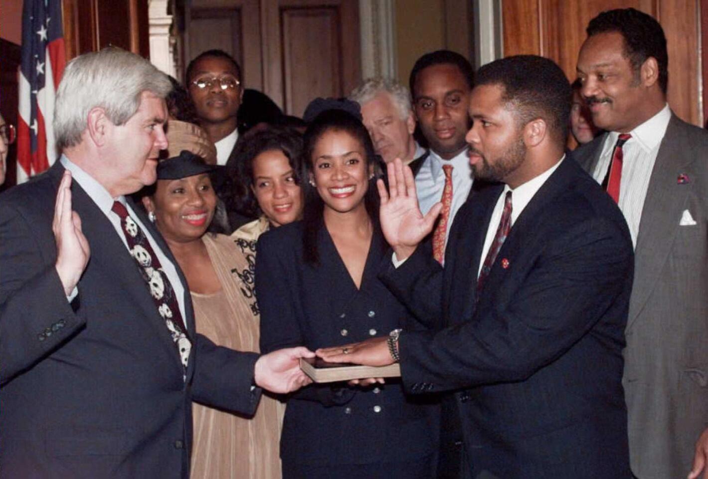 Speaker of the House Newt Gingrich, left, re-enacts the swearing-in of the newest member of Congress, Jesse Jackson Jr. (R), D-IL. on Dec. 14, 1995. In the background are congressmen Jackson's mother, Jackie, his wife Sandri, center, and his father, civil rights leader the Rev. Jesse Jackson.