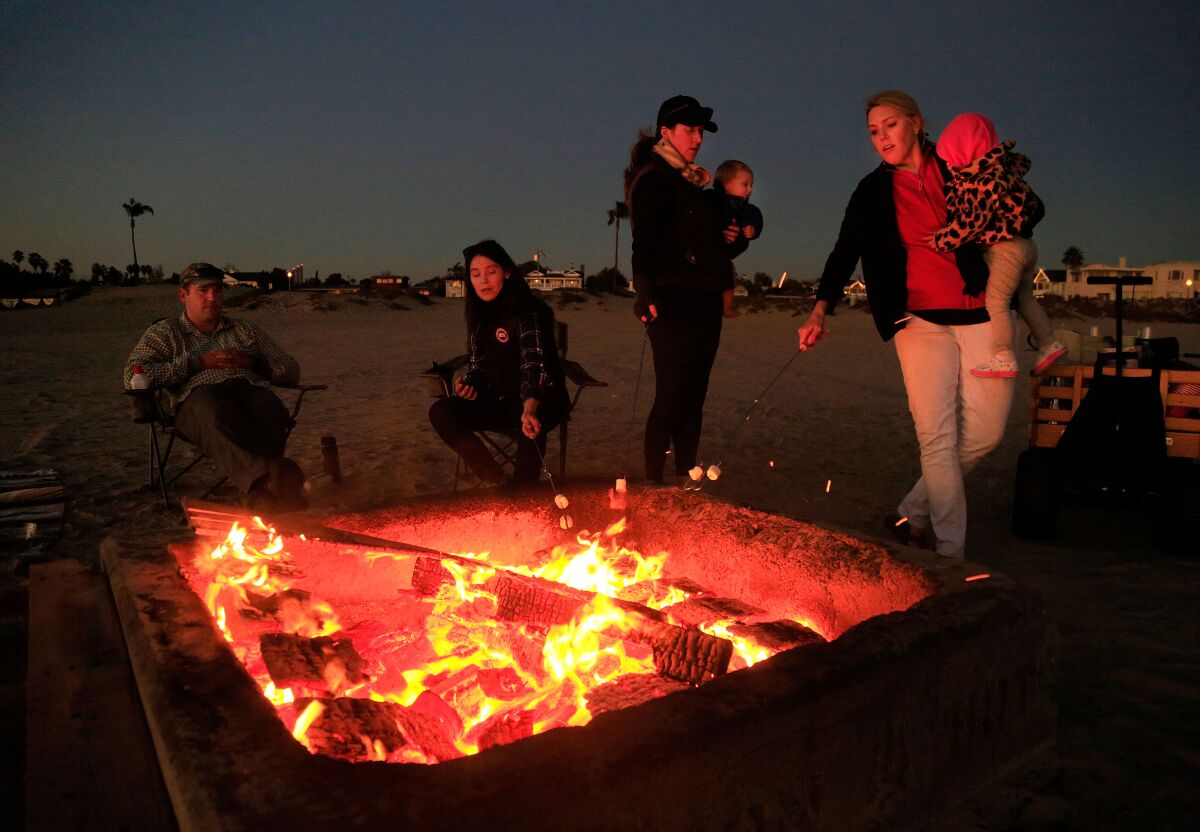 A family gathers around a bonfire  in Coronado in this file photo.