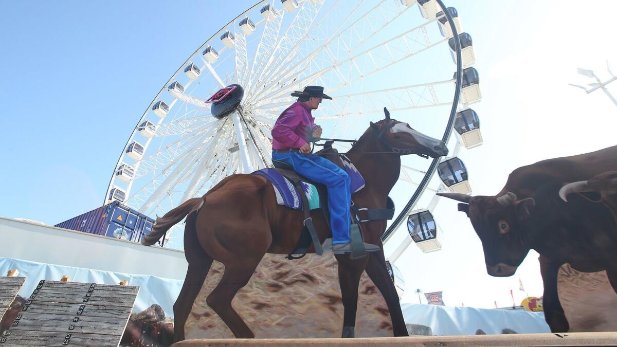 Cowboy Frank Fitzpatrick is shown representing 5 Bar Beef, one of three large murals featured in the "Bounty of the County" series at the Orange County Fair.