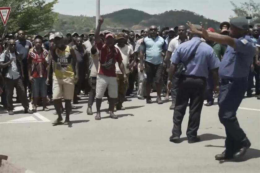 This image made from video shows a protest in Port Moresby, Papua New Guinea on Jan. 10, 2024. The Papua New Guinea government worked to restore order Thursday after multiple people were reportedly killed during rioting and looting that left the country’s two biggest cities in flames. (Australian Broadcasting Corp. via AP)