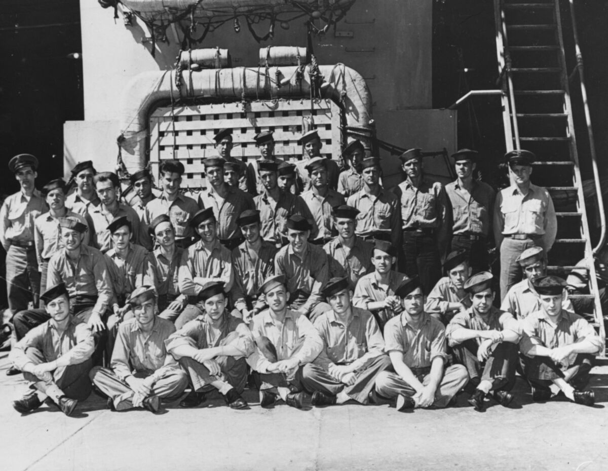 Members of the ship's crew pose in the well deck, during World War II. Photograph was taken prior to her final overhaul (completed in July 1945), as life rafts are of a different pattern than carried after that overhaul. Photograph was received by the Naval Photographic Science Laboratory on 24 August 1945. Official U.S. Navy Photograph, now in the collections of the National Archives.