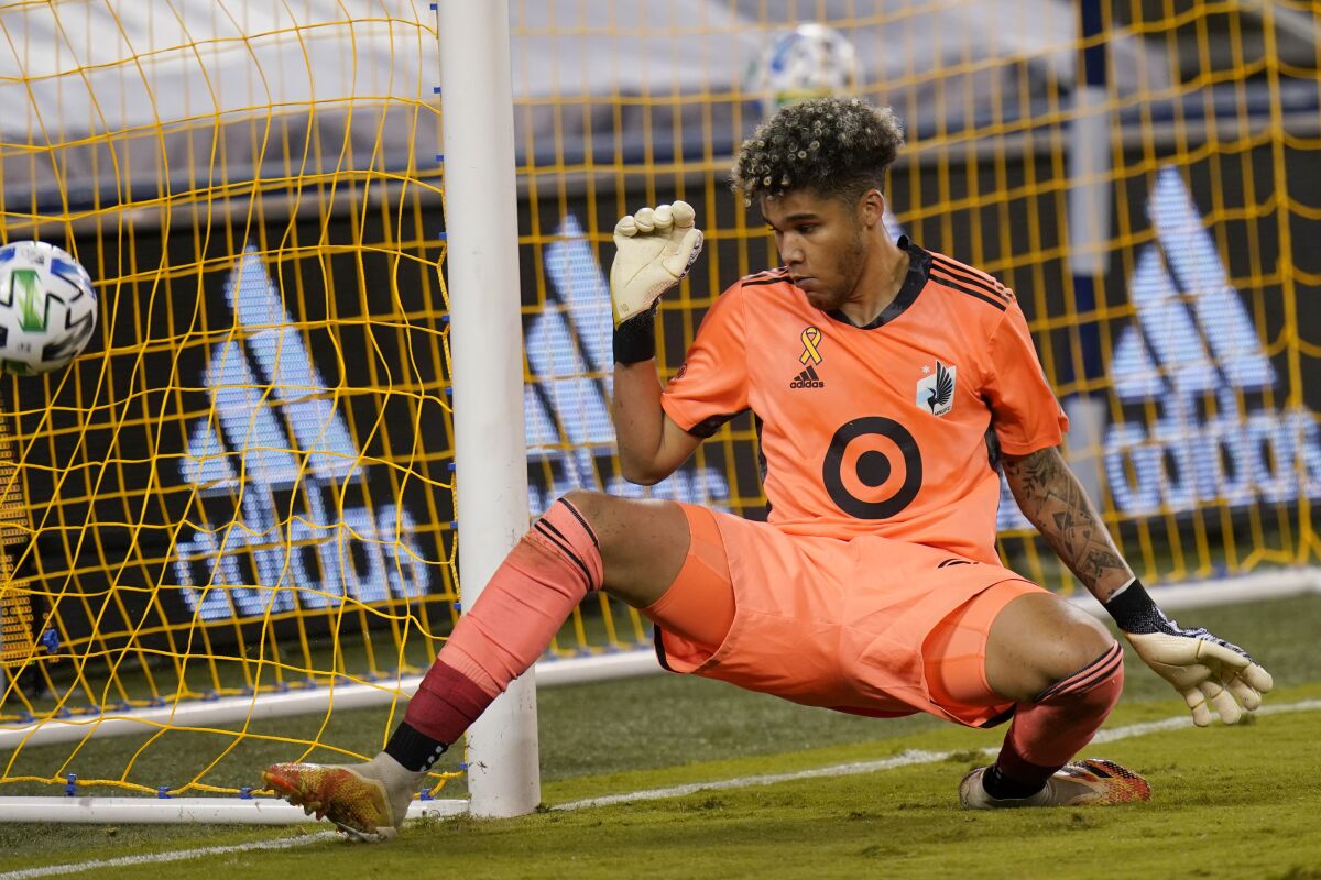 Minnesota United goalkeeper Dayne St. Clair defends the post during the first half of an MLS soccer match against Sporting Kansas City in Kansas City, Kan., Sunday, Sept. 13, 2020. (AP Photo/Orlin Wagner)