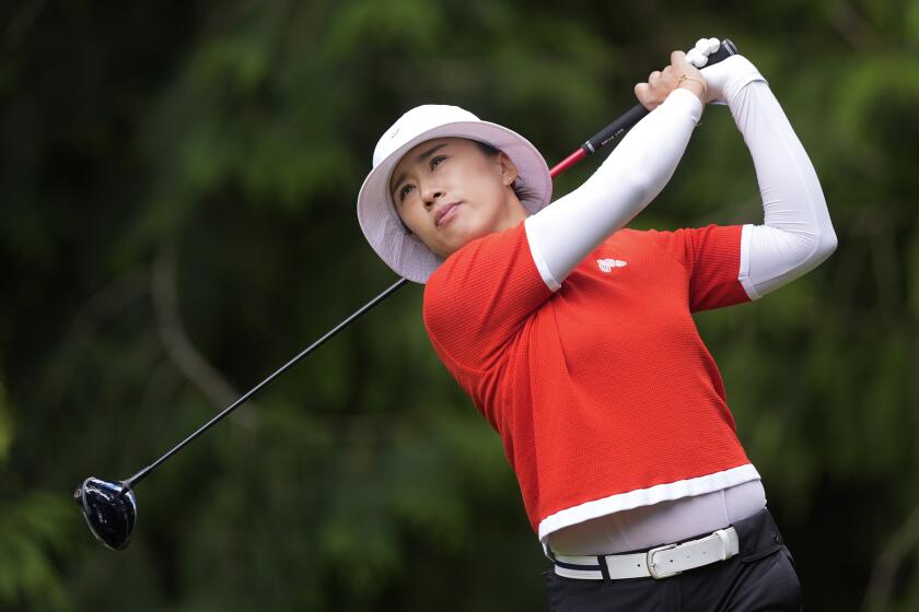 Amy Yang, of South Korea, watches her shot after hitting from the fourth tee.