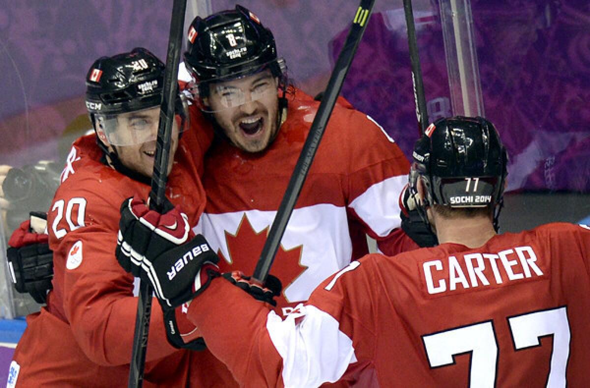 Canada defenseman Drew Doughty celebrates with teammates after scoring the winning goal in overtime against Finland on Sunday in a preliminary-round game at the Sochi Olympics.