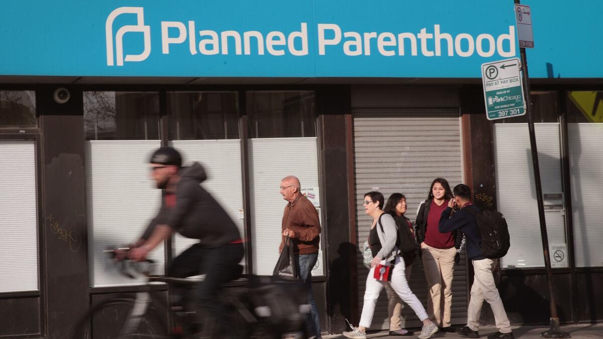 Pedestrians walk past a Planned Parenthood clinic in Chicago on May 18.