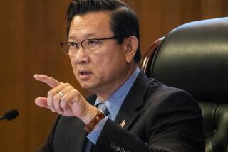 SANTA ANA, CA - JULY 14: Orange County Board of Supervisors Andrew Do, vice chairman, first district, warns hecklers to not interrupt fellow speakers during its regular board meeting at the Orange County Hall of Administration on Tuesday, July 14, 2020 in Santa Ana, CA. OC Supervisors also discussed a file status report and approve continuance of local health emergency and local emergency related to Novel Coronavirus (COVID-19) and set a review to continuing local emergency and every 30 days after until terminated. They also discussed a resolution in support of a ban on affirmative action introduced by Supervisors Michelle Steel and Don Wagner and a proposal from Supervisors Lisa Bartlett and Doug Chaffee to alter the county's term limits for supervisors. (Allen J. Schaben / Los Angeles Times)