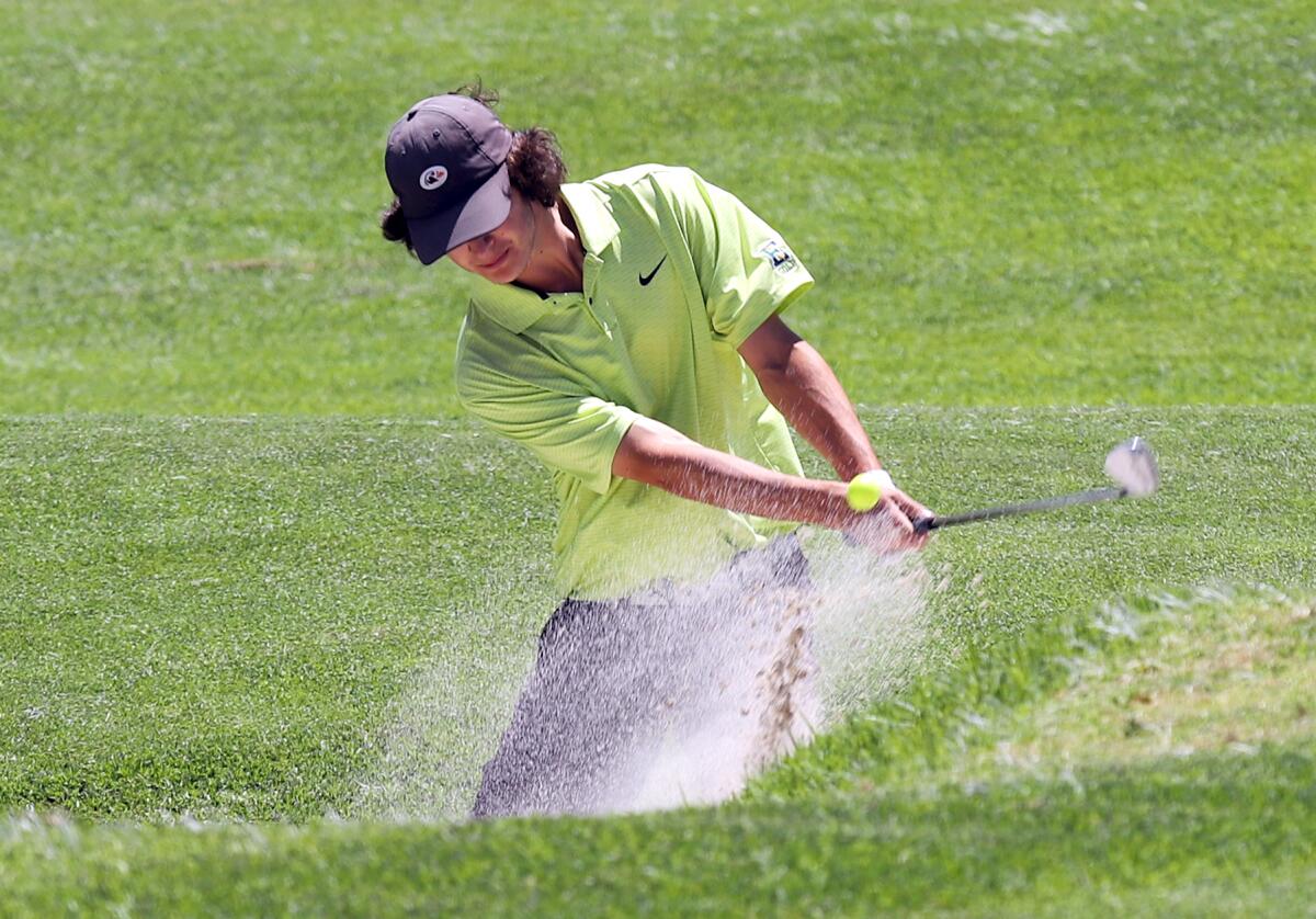 Edison's Jake Rothman chips out of the bunker during the CIF State boys' golf championship at the San Gabriel Country Club.