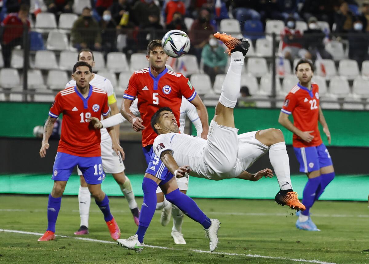 Uruguay's Luis Suárez, center, does a back kick to score against Chile during a World Cup qualifier in March.