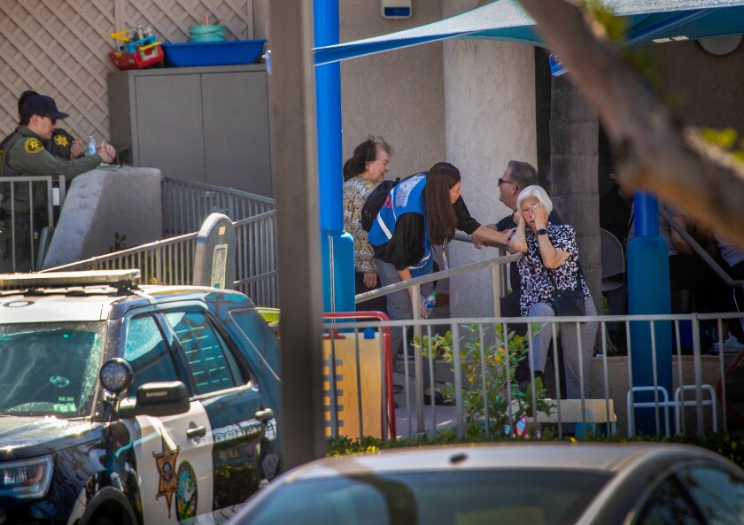 A woman comforts an older woman who appears to be crying.