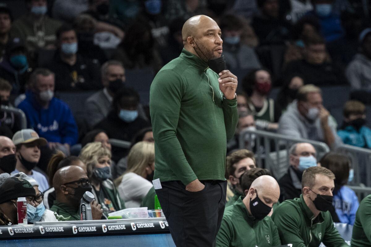 Darvin Ham stands along the sideline watching a Bucks-Hornets game in January.