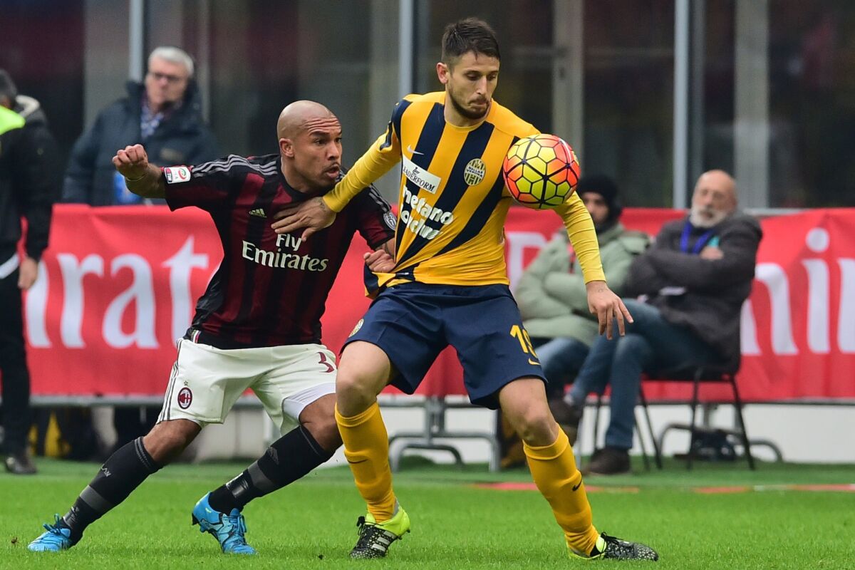 Nigel de Jong fights of AC Milan fights for the ball with Leandro Greco of Hellas Verona, right, during a Serie A match on Dec. 13.