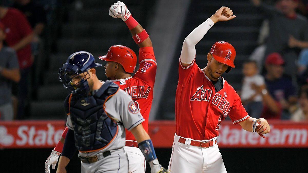 Angels' Luis Valbuena, center, is congratulated by Andrelton Simmons, right, after hitting a two-run home run, as Houston Astros catcher Max Stassi stands at the plate during the first inning on Wednesday.