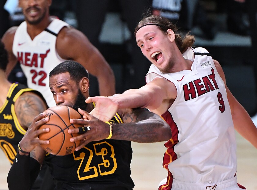 The Lakers' LeBron James grabs a rebound from Heat's Kelly Olynyk in Game 2 of the NBA Finals on Oct. 2, 2020.