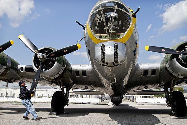 Crew chief David Miller tugs on a propeller of the Liberty Belle, a restored World War II-era Boeing B-17 "Flying Fortress" bomber, after flying over Los Angeles with members of the media. The event was part of the Liberty Foundation's 2011 "Salute to Veterans" tour. The plane will be open to the public and available for flights this weekend at Bob Hope Airport in Burbank.