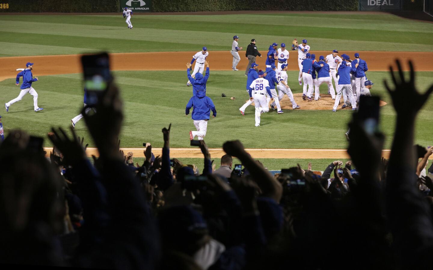 The Chicago Cubs and fans celebrate a 5-0 win over the Los Angeles Dodgers in Game 6 of the NLCS to advance to the World Series.