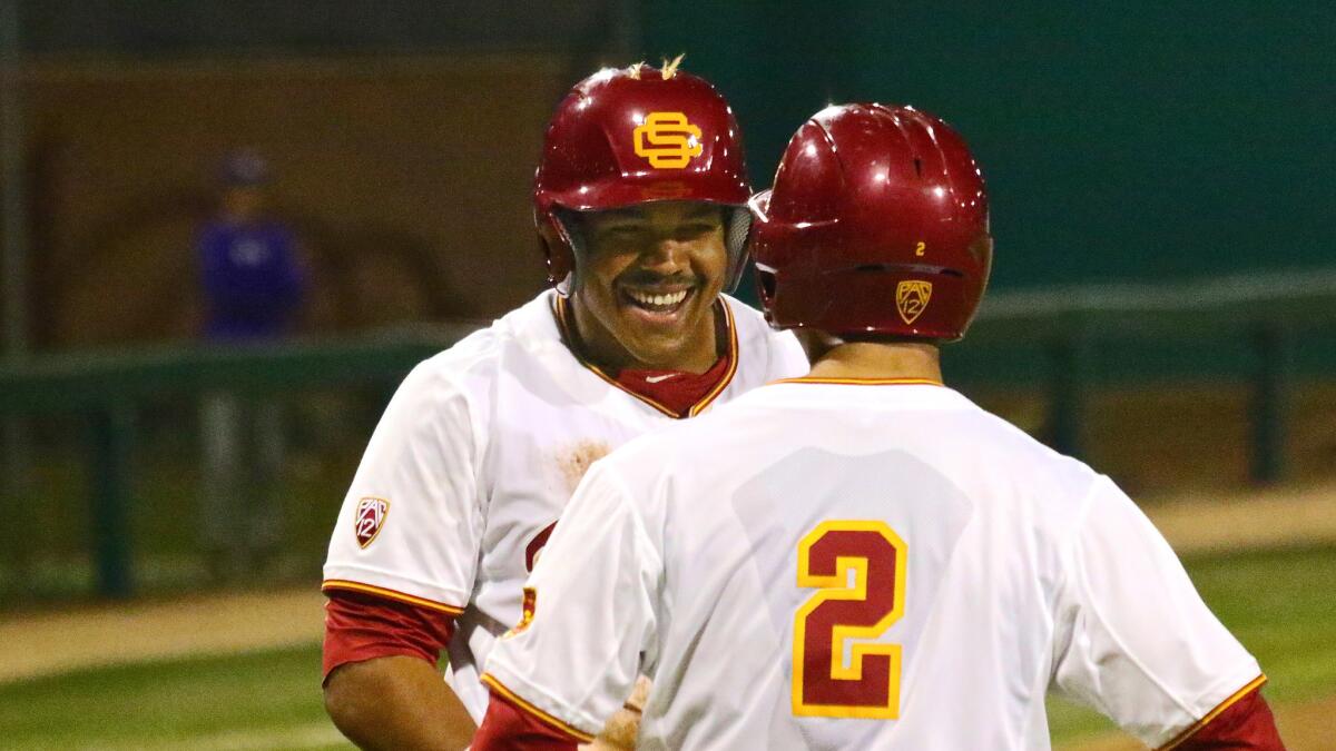 USC outfielder Timmy Robinson is all smiles after scoring a run earlier this season.