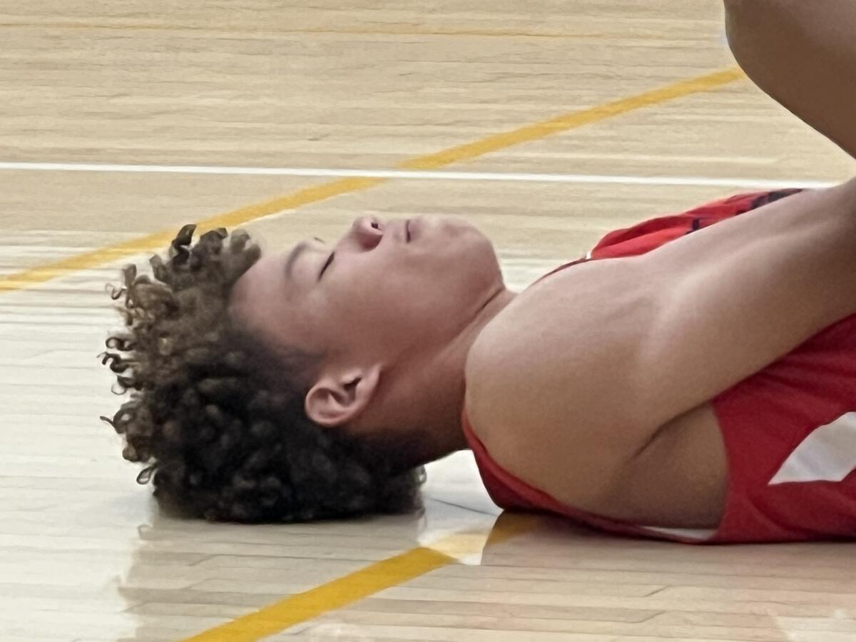 Junior guard Trent Perry of Harvard-Westlake stretches.