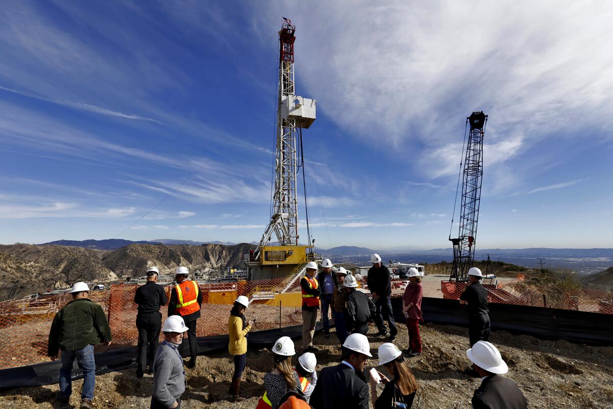 Several people stand around a relief well being drilled at Aliso Canyon in December 2015.